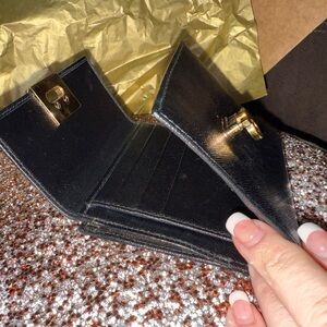 Black Leather Ferragamo Wallet with Gold Hardware. Pure Italian luxury.